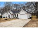 Newly renovated white house with a gray roof and attached garage at 9004 English Saddle Ln, Charlotte, NC 28273