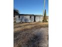 Two gray storage sheds sit on a gravel driveway at 9697 Us 52 N Hwy, Wadesboro, NC 28170