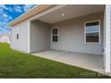 Covered patio with concrete flooring and grassy backyard at 108 Sandypark Ct, Troutman, NC 28166