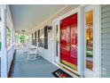 Front porch with rocking chairs and red front door at 165 Pine Valley Dr, Stanley, NC 28164