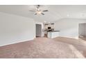 Spacious living room with neutral carpeting and hardwood flooring, open to kitchen at 171 Wembury Ln, Troutman, NC 28166
