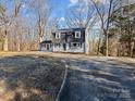 Ranch-style home with a long driveway and mature trees at 188 Mary Cir, Concord, NC 28025