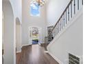 Two-story foyer with hardwood floors, staircase, and high ceilings at 2010 Lake Forest Dr, Tega Cay, SC 29708