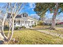 White house with walkway, mature trees, and a well-maintained lawn at 257 Jefferson St, Statesville, NC 28677