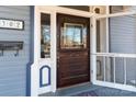 Ornate wood front door with glass panels and screen at 302 S College St, Monroe, NC 28112