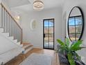 Bright and airy entryway with a statement chandelier and herringbone floors at 3027 Westfield Rd, Charlotte, NC 28209