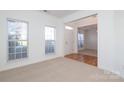 Bright living room with hardwood floors, neutral walls, and large windows at 4030 Garden Oak Dr, Indian Trail, NC 28079