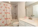 Small bathroom with flamingo shower curtain, tub, and vanity at 457 Lahinch Dr, Tega Cay, SC 29708