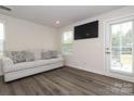 Cozy sitting area with light gray couch and access to backyard at 457 Lahinch Dr, Tega Cay, SC 29708
