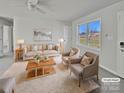 Virtually staged living room with neutral colors and large windows at 495 Drumstand Rd, Stony Point, NC 28678