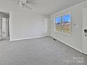 Bright living room with grey carpet and large window at 495 Drumstand Rd, Stony Point, NC 28678