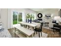 Open concept kitchen, dining area, and living room with hardwood floors and white farmhouse table at 5149 Fireweed Ct, Dallas, NC 28034