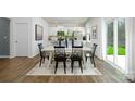Kitchen and dining area with hardwood floors, white table and black chairs, and access to backyard at 5149 Fireweed Ct, Dallas, NC 28034
