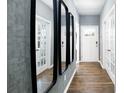 Bright entryway with hardwood floors, three mirrors, and French doors at 5149 Fireweed Ct, Dallas, NC 28034