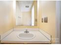 Simple, clean bathroom with a white sink and mirror at 6303 Windsor Gate Ln, Charlotte, NC 28215