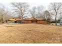 One-story home with orange siding, mature trees, and a large yard at 664 Freemont Dr, Lancaster, SC 29720