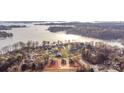 Breathtaking aerial view of waterfront homes nestled amidst lush trees and the tranquil lake, with construction underway on new properties at 8078 Blackwood Rd, Denver, NC 28037