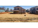 New construction backyard with immature landscaping and wooden porch at 8078 Blackwood Rd, Denver, NC 28037