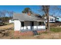 White house exterior with a porch and steps, situated on a lot with trees at 1024 Chester Ave, Great Falls, SC 29055