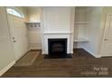 Bright entryway with hardwood floors, shiplap accent wall, and gas fireplace at 10515 Rocky Ford Club Rd, Charlotte, NC 28269