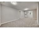 Spacious basement with gray walls and carpeted floors at 109 Belton Ave, Mount Holly, NC 28120