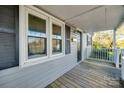 Wooden front porch with gray siding and white railings at 109 Belton Ave, Mount Holly, NC 28120