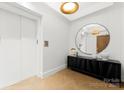 Bright entryway, featuring a large mirror and contemporary console at 130 Cherokee Rd # 304, Charlotte, NC 28207