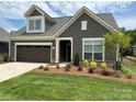 Gray house with brown garage door and landscaping at 1330 Millview Ln, Matthews, NC 28104