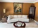 Living room with beige sofa and antique furniture at 1330 Millview Ln, Matthews, NC 28104