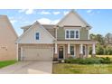 Charming two-story home featuring stone accents, attached two car garage and covered front porch at 2006 Houle Ln, Charlotte, NC 28214