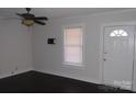Simple living room featuring dark hardwood floors and a ceiling fan at 303 Vance Ave, Salisbury, NC 28144