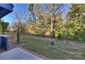 Landscaped backyard with mature trees and a spacious grassy area at 3113 Colyer Pl, Charlotte, NC 28205