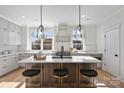 Modern kitchen with island, stainless steel appliances, and white cabinetry at 3113 Colyer Pl, Charlotte, NC 28205