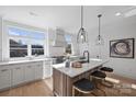 Modern kitchen with white cabinets, island, and stainless steel appliances at 3113 Colyer Pl, Charlotte, NC 28205