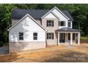 Charming two-story home with brick, light-colored siding, and a covered front porch at 4251 Candlewood Dr, Sherrills Ford, NC 28673
