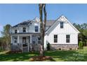 Charming two-story home featuring white siding, stone accents, and a well-manicured lawn at 4257 Candlewood Dr # 7, Sherrills Ford, NC 28673