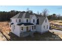 Exterior view of a new two story home featuring a covered front porch and white board and batten siding at 4257 Candlewood Dr # 7, Sherrills Ford, NC 28673