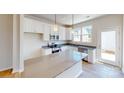 Modern kitchen featuring white cabinets and an island at 8105 Jacey Ln # 39, Huntersville, NC 28078