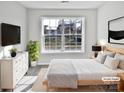 Virtually staged bedroom with large window and modern dresser at 8035 Bristle Ln, Charlotte, NC 28214