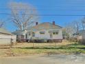 Back view of a home with a detached garage, surrounded by a chain-link fence at 85 5Th St, Cramerton, NC 28032