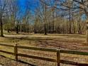 Scenic backyard view of a lush, wooded landscape with a charming wooden fence at 85 5Th St, Cramerton, NC 28032