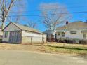 Bungalow style home with adjacent garage and fenced yard, showcasing a classic design at 85 5Th St, Cramerton, NC 28032