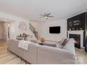 Spacious living room with a fireplace, large sectional sofa, and flat-screen TV at 8903 Ansley Park Pl, Huntersville, NC 28078
