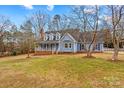 Charming blue two-story home featuring a welcoming front porch and dormer windows at 111 Wheaton Ct, Salisbury, NC 28147