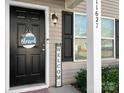 Front entrance with black door, welcome sign, and lantern light at 11627 Tribal Dr, Charlotte, NC 28214