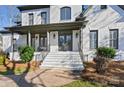 Impressive front entrance with double doors, stone steps, and landscaping at 11917 James Jack Ln, Charlotte, NC 28277