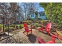 Relaxing brick patio with red Adirondack chairs and fire pit at 1204 Buchanan St, Charlotte, NC 28203