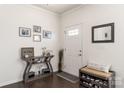 Bright entryway with console table, mirror, and shoe bench at 1216 Longwall Ln, Matthews, NC 28105