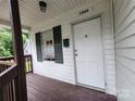 Front door entrance with dark brown porch and green shutters at 1300 Brookdale St, Kannapolis, NC 28083