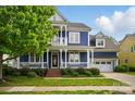 Charming blue two-story home with a welcoming front porch and well-maintained landscaping at 2607 White Pines Ct, Monroe, NC 28112